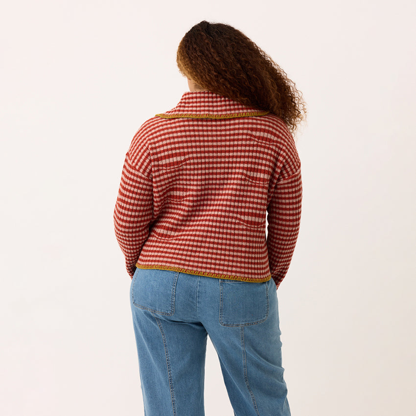 A back view of the Nancybird Lulu Knit in Ginger Petal on a model on a blank background