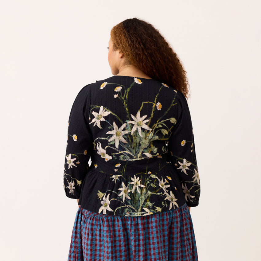 A back view of the Nancybird Mabel Top in Still Life on a model on a blank background