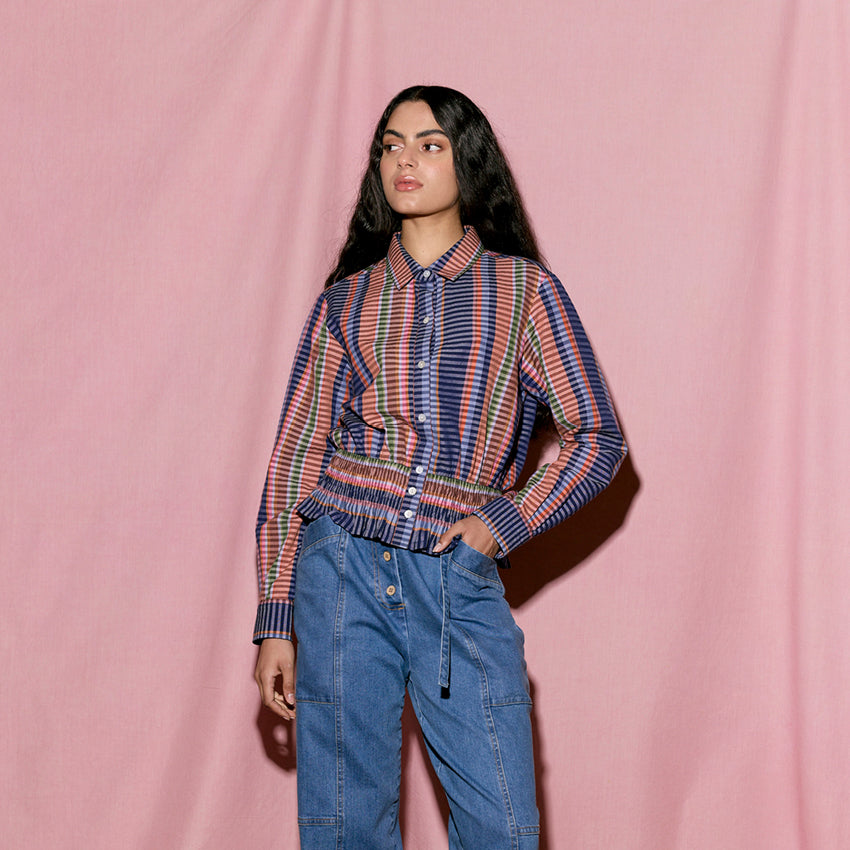 The Nancybird Orla Shirt in Line Check on a model on a pink background