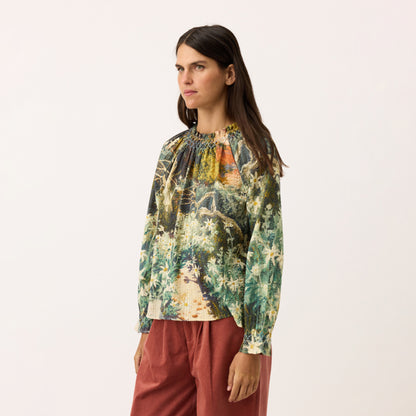 A side view of the Nancybird Rowena Shirred Blouse in Flannel Flower on a model on a blank background