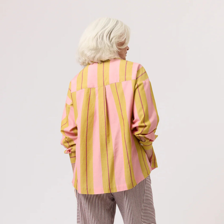 The back of the Nancybird Sabine Shirt in Dusk Stripe on a model on a blank background