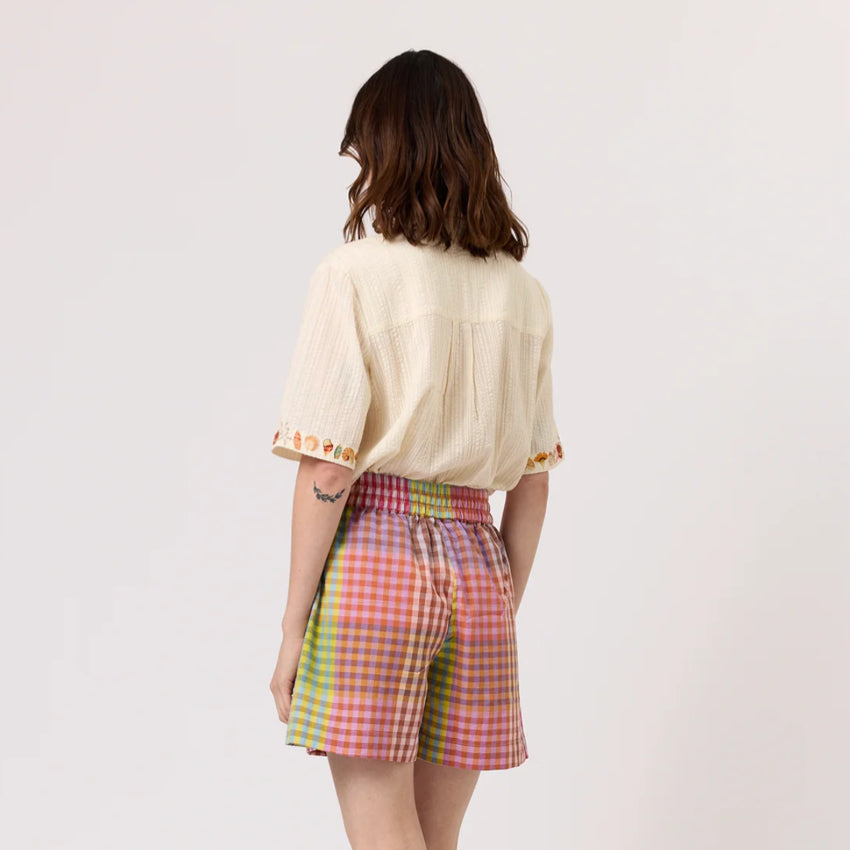 The back of the Nancybird Zana Shorts in Sunrise Check on a model on a blank background