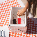 The Napoleon Goods Mini Chilly Bin in Coconut White with ice and ice blocks in it on a towel 