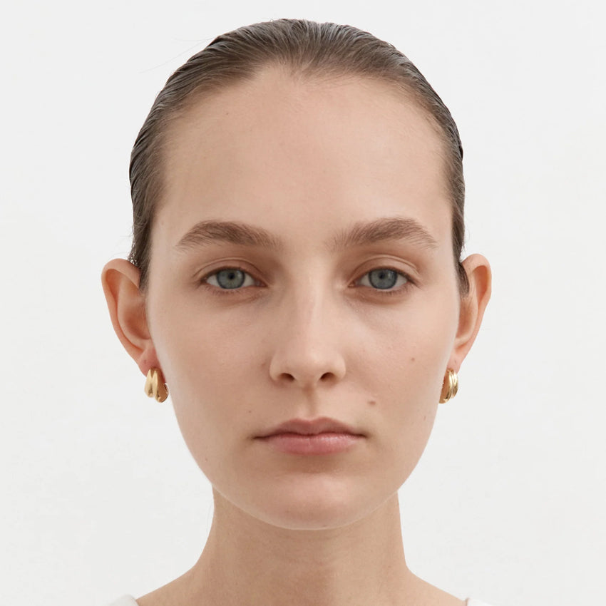 The Nina Gordon Small Mega Hoops in Gold Plated on a model