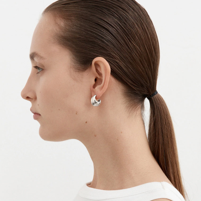 The Nina Gordon Small Mega Hoops in Sterling Silver on a model