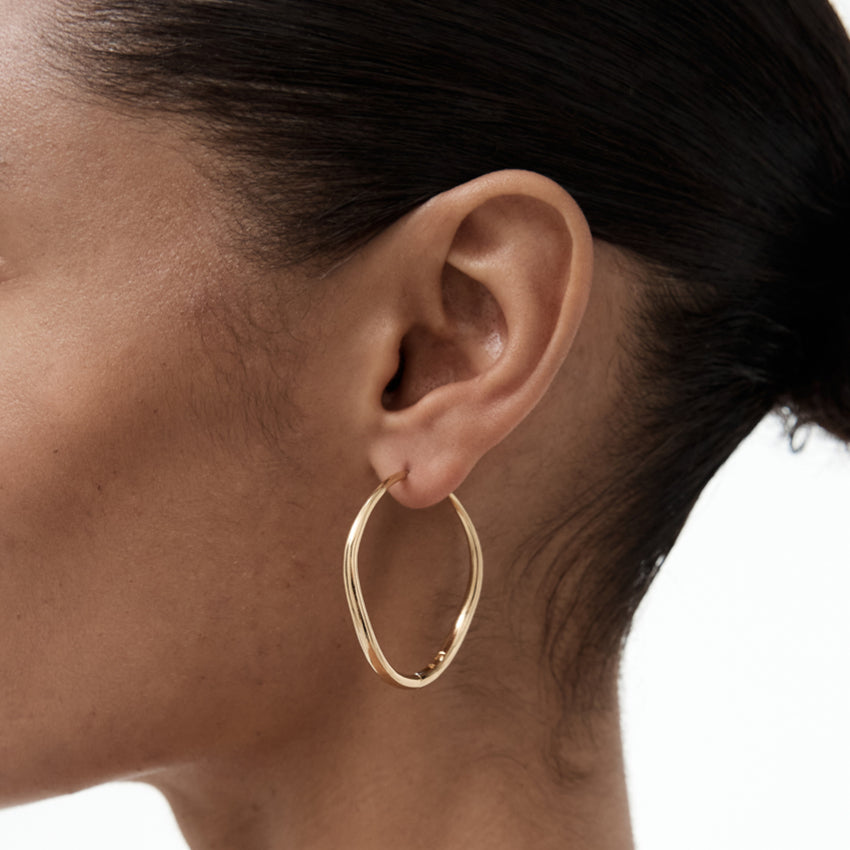 The Nina Gordon Large Momento Hoops in 14k Vermeil on a model