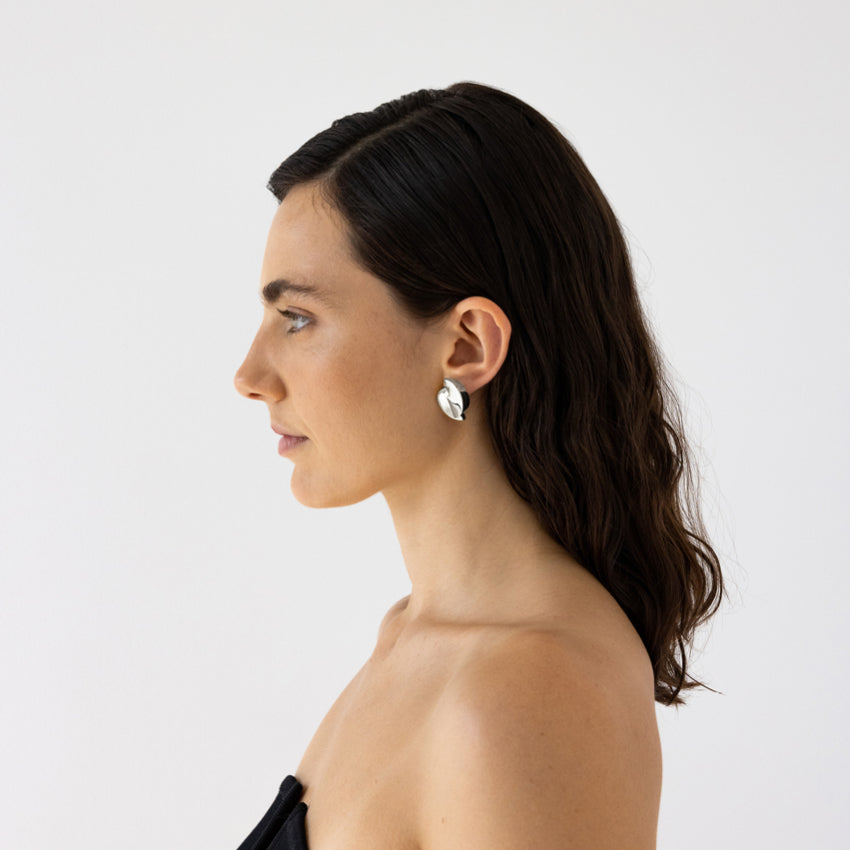 The Nina Gordon 1989 Dome Earrings in Silver on a model