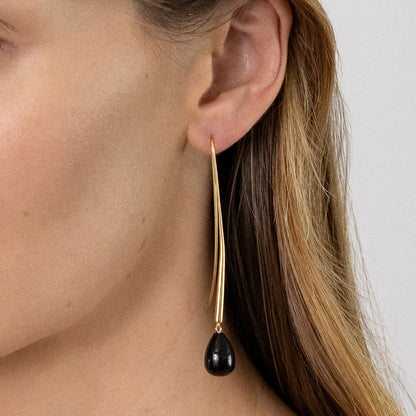 The Nina Gordon Cusp Onyx Earrings in Gold on a model