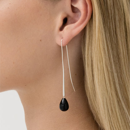 The Nina Gordon Cusp Onyx Earrings in Silver on a model