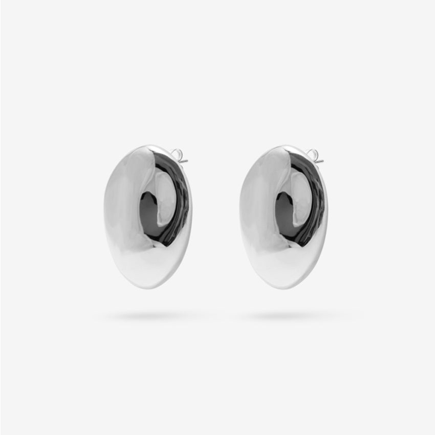 The Nina Gordon Dylan Dome Earrings in Silver on a blank background