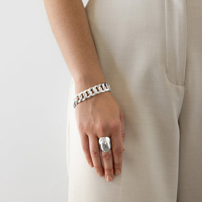 The Nina Gordon Dylan Dome Ring in Silver on a model paired with a bracelet