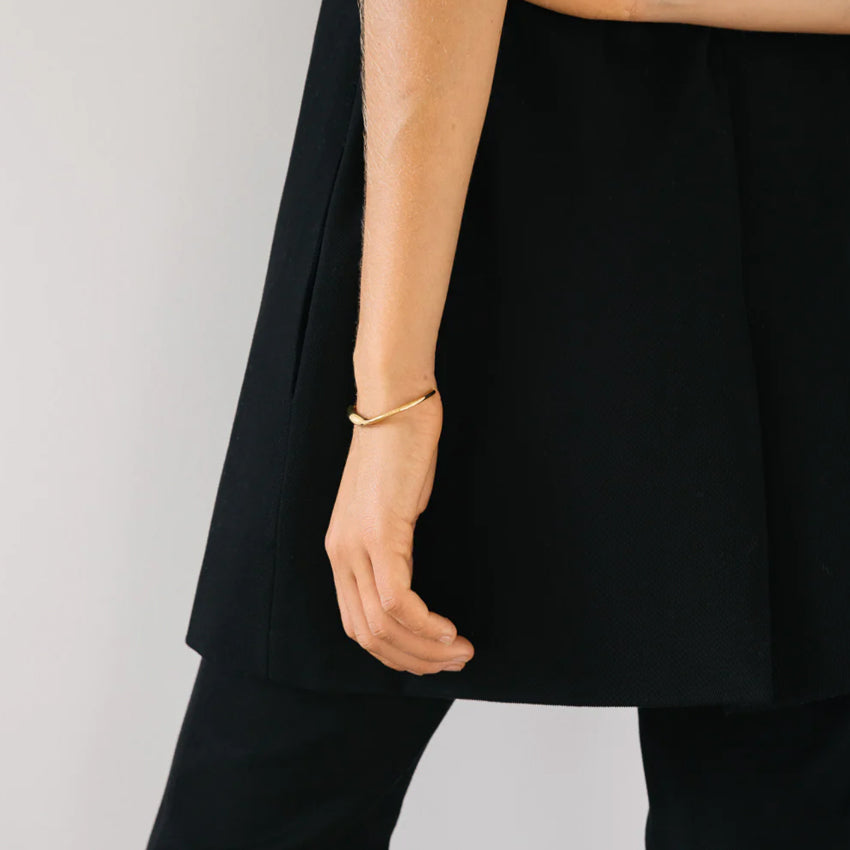 The Nina Gordon Lucid Wrist Cuff in Gold on a model's wrist