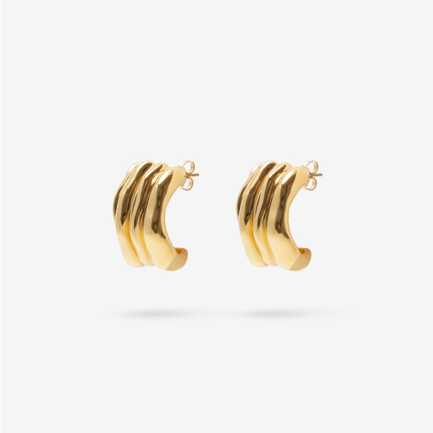 The Nina Gordon Vertigo Earrings in Gold on a blank background