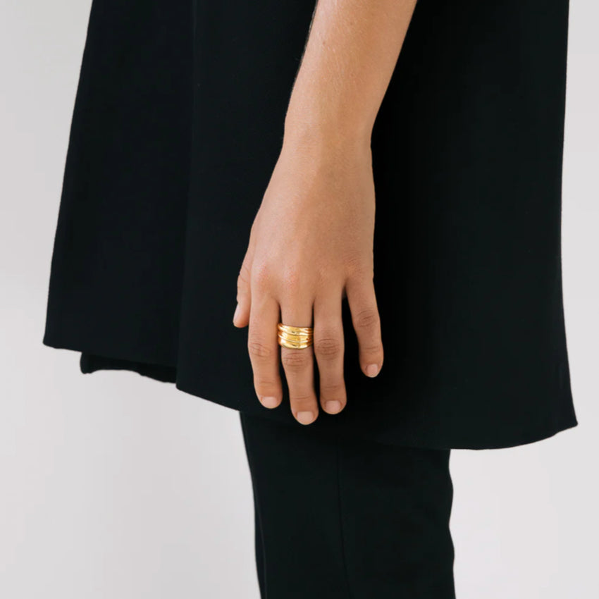 The Nina Gordon Vertigo Ring in Gold on a model's finger