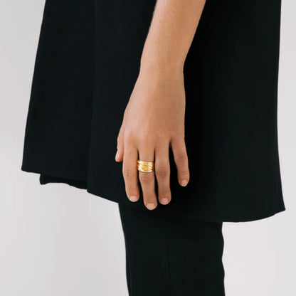 The Nina Gordon Vertigo Ring in Gold on a model's finger