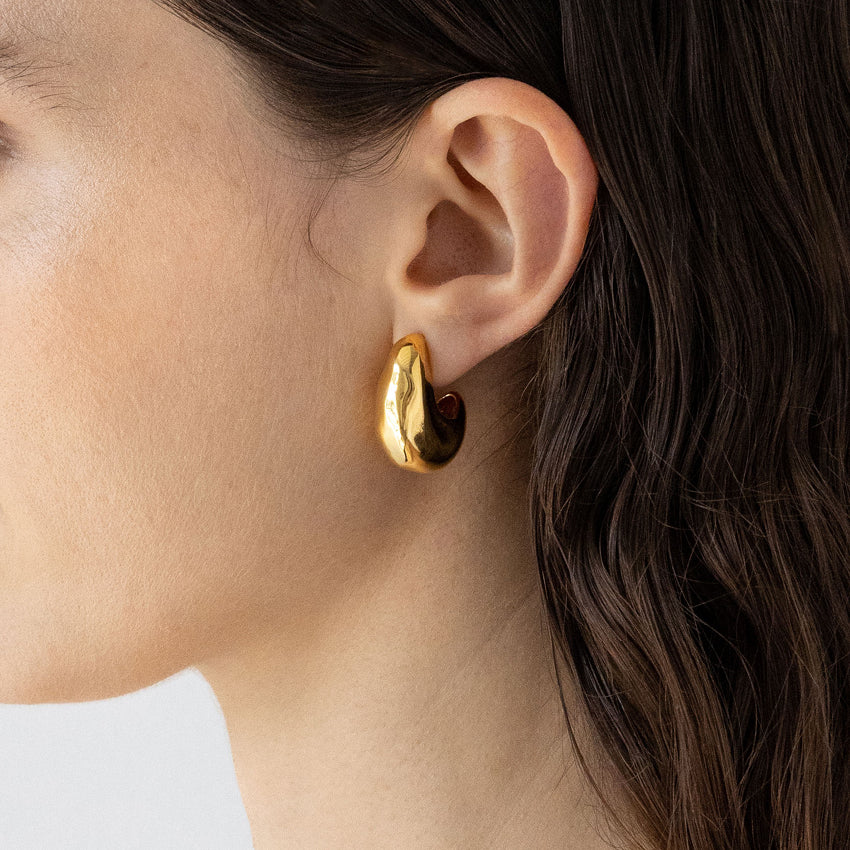 The Nina Gordon Volume Hoops in Gold on a model