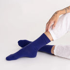 Person wearing royal blue Nooan Hamilton Possum and Merino Wool socks with a white background