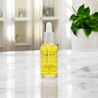 The Nude Kiwi Recovery Concentrate Oil on a marble countertop