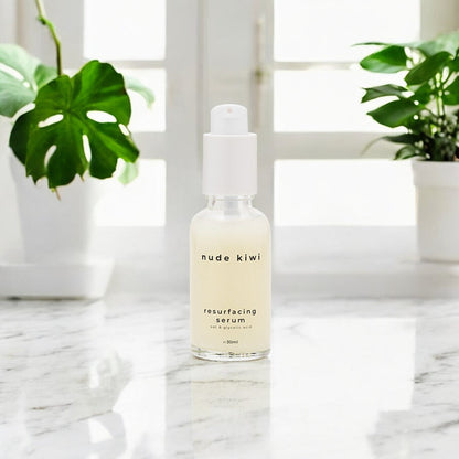 The Nude Kiwi Resurfacing Serum on a marble countertop