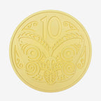 The One Lane Bridge 10 Cent Candy Coin in yellow on a blank background