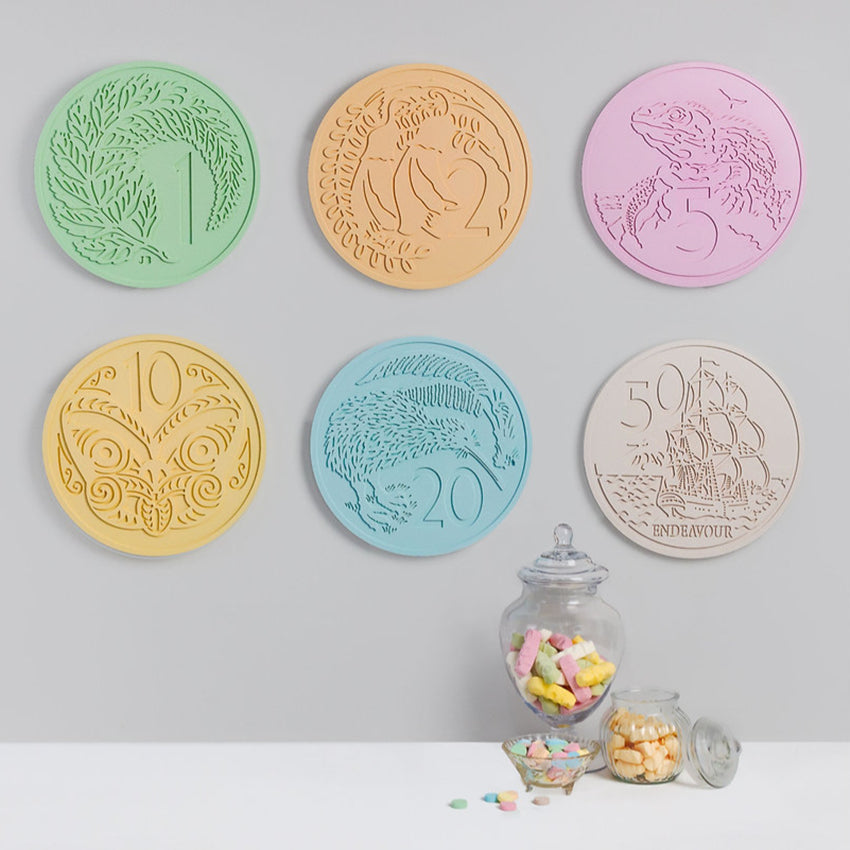 Six of the One Lane Bridge Candy Coins hanging on a wall