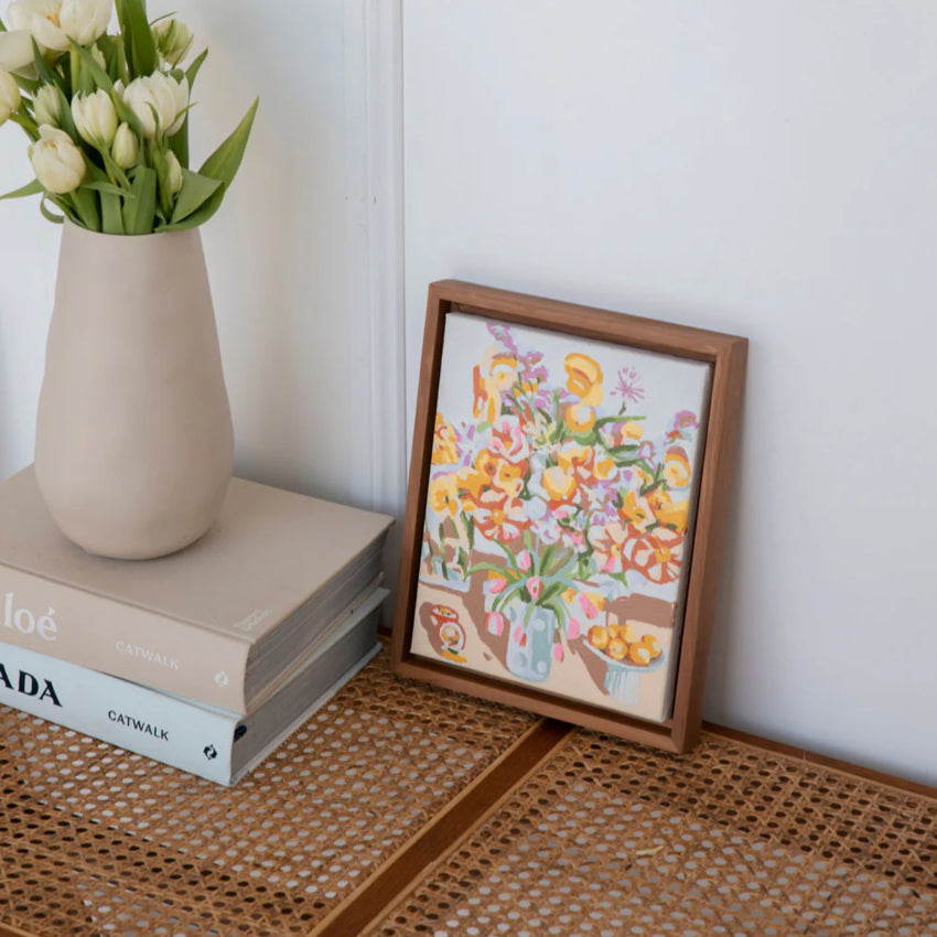 The Paint Like Frida Paint By Numbers Small Birthday Flowers in Canvas framed on a table