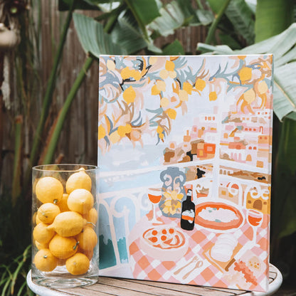 The Paint Like Frida Positano Paint By Numbers on a canvas on a side table next to lemons