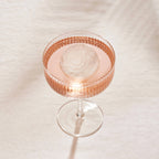 A Peak Petal Cocktail Ice in a cocktail glass with a drink