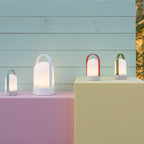 The Remember URI Lamps turned on, on side tables outside 