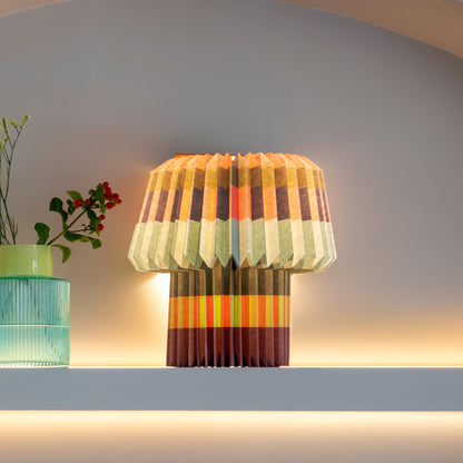 The Remember Paper Lamp in Anna Blocks print glowing on a shelf next to a vase