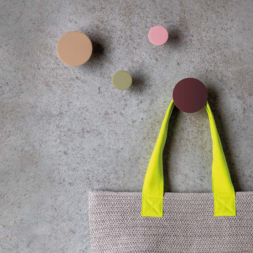 The Remember Homewares Wall Hooks set of 4 on a grey wall with a bag hanging on one