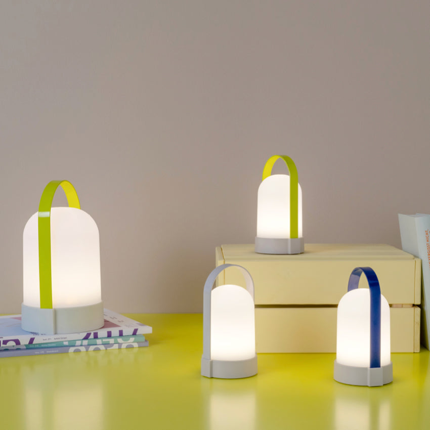 Three of the Remember UTI Piccolo Lamps with a larger one on a yellow desk