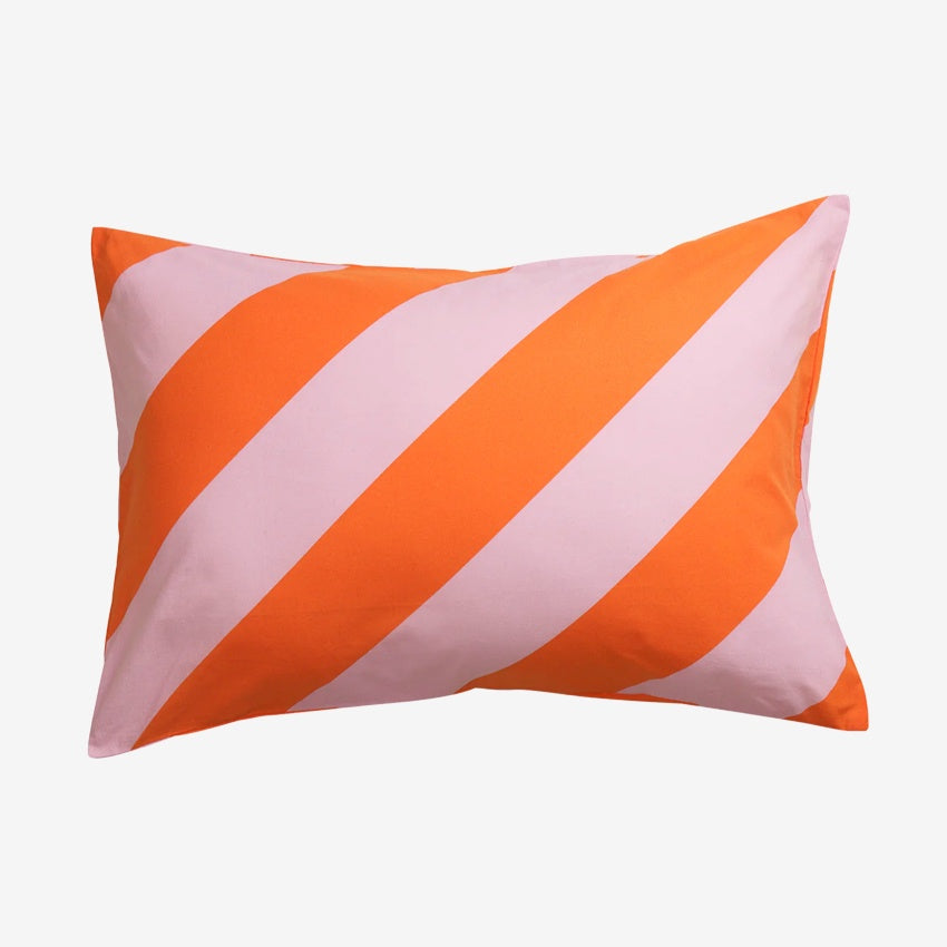 The Sage x Clare Clarice Cotton Pillowcase on a grey background