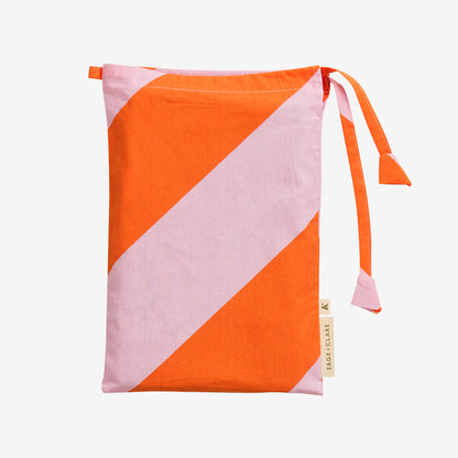 The bag for the Sage x Clare Clarice Cotton Pillowcase on a grey background