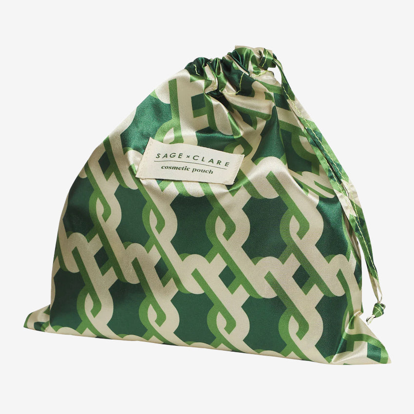 The bag for the Sage x Clare Delphine Cosmetic Pouch in Anise on a grey background