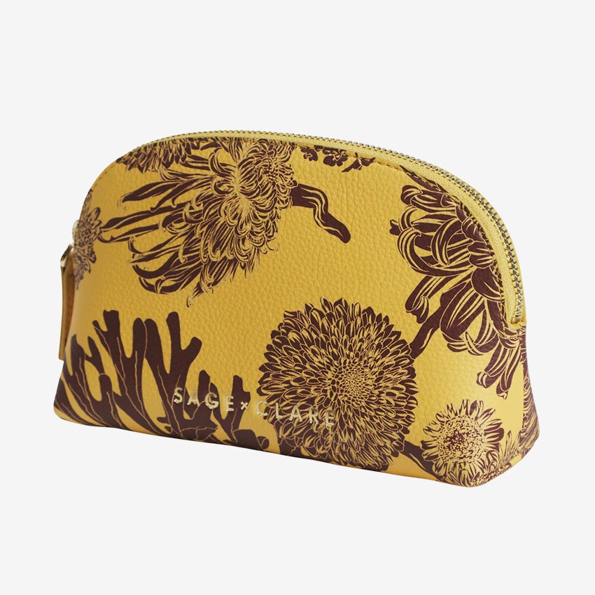 The Sage x Clare Delphine Cosmetic Pouch in Dune on a grey background