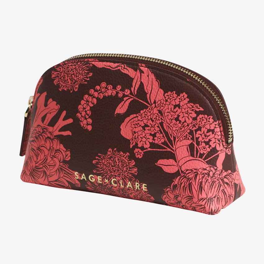 The Sage x Clare Delphine Cosmetic Pouch in Garnet on a grey background