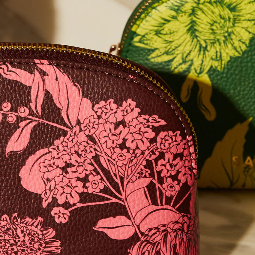 A closeup of the Sage x Clare Delphine Cosmetic Pouch in Garnet 