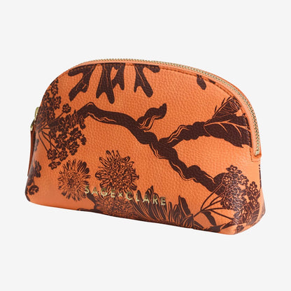 The Sage x Clare Delphine Cosmetic Pouch in Vivid Coral on a grey background