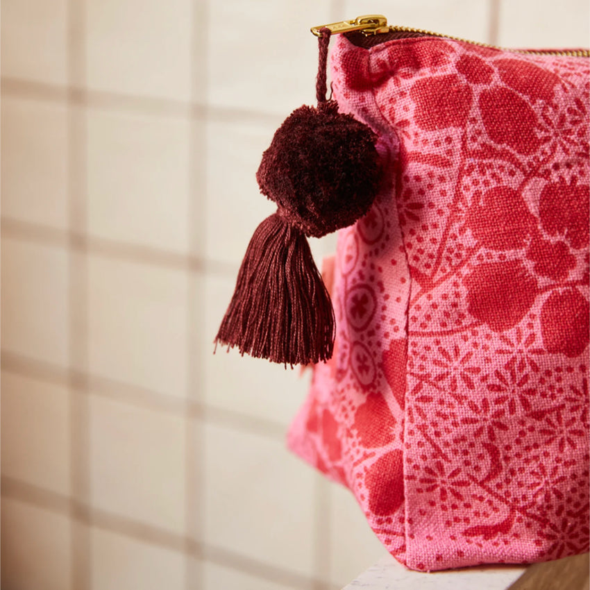 A closeup of the Sage x Clare Salina Cosmetic Bag in a bathroom.