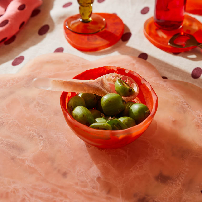A Sage x Clare Billie Bowl in Mandarin with fruit in it on a table.