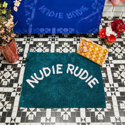 The Sage x Clare Nudie Rudie Bathmat in Peacock on a tiled bathroom floor