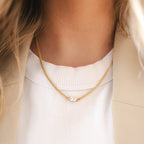 The Silver Linings Collective Cleo Necklace in Gold on a model 