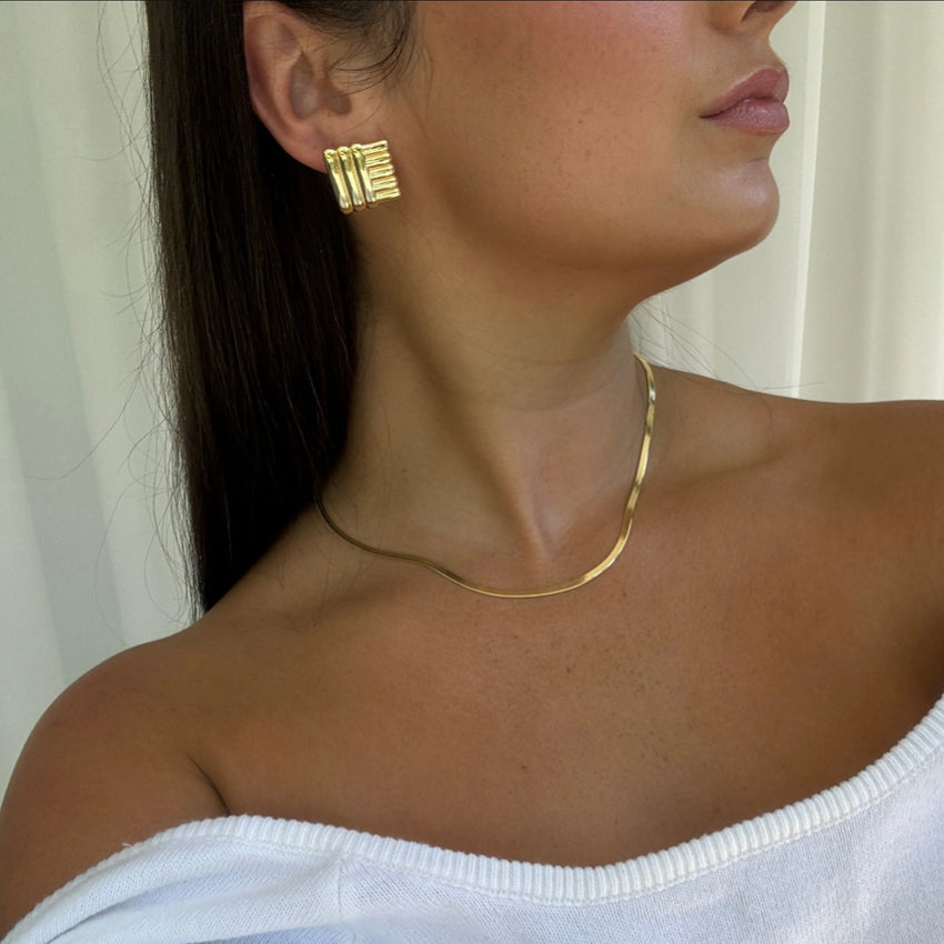 The Silver Linings Collective Di Earrings in Gold on a model
