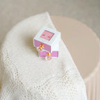 The Silver Linings Collective Kids Earrings boxes on a blanket and stool