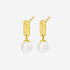 The Silver Linings Collective Luna Pearl Earrings in Gold on a blank background