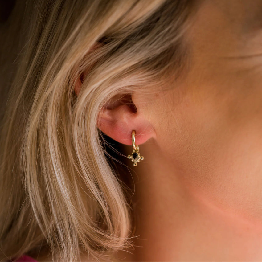 The Silver Linings Collective Monarchy Hoops in Gold on a model
