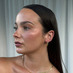 The Silver Linings Collective Navy Hoops in Gold on a model