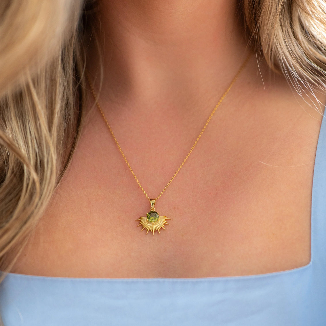 The Silver Linings Collective Solace Necklace with a Peridot Stone in Gold on a model