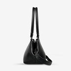 A side profile of the Status Anxiety Astral Bag in Black on a blank background